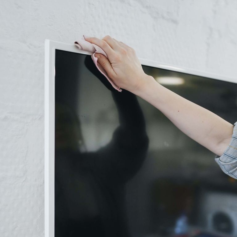 hand dusting television